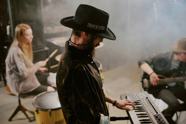 istock Young Man Wearing Hat Playing Keyboard In Band 2162138132