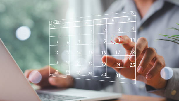 istock Time management concept. Businessman manages time for effective work. Calendar on the virtual screen interface. Highlight appointment reminders and meeting agenda on the calendar. 2162138277