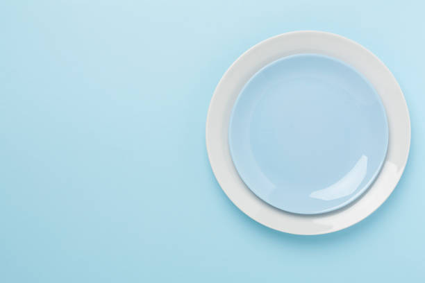 istock Empty plate with tablecloth on color background, top view 2162138660