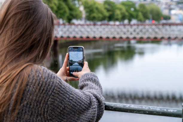 istock Young woman taking photos with her smartphone. 2162140680