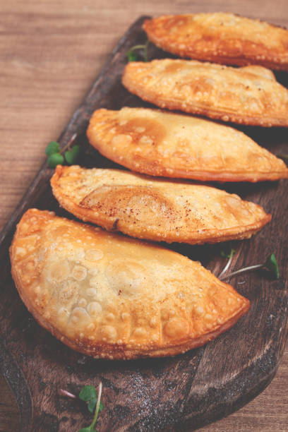 istock fried chebureks, deep-fried, mini, on a chopping board, wooden table, close-up, no people, 2162140820