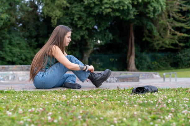 istock Young brown haired woman taking off her shoes. 2162140955