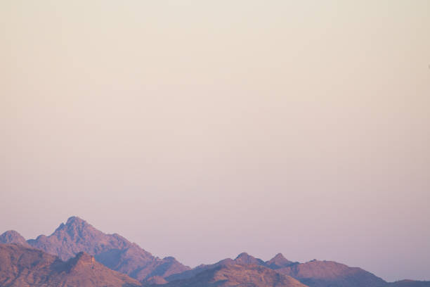 Colorful desert sky with mountains and copy space.
