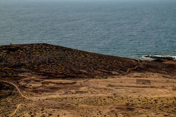 istock A beach with a hill in the background 2162147289