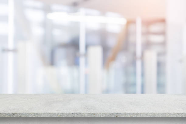 istock Abstract blurred  interior modern office room background with perspective cement quartz table for show, promote and design content or product on display concept 2162148046