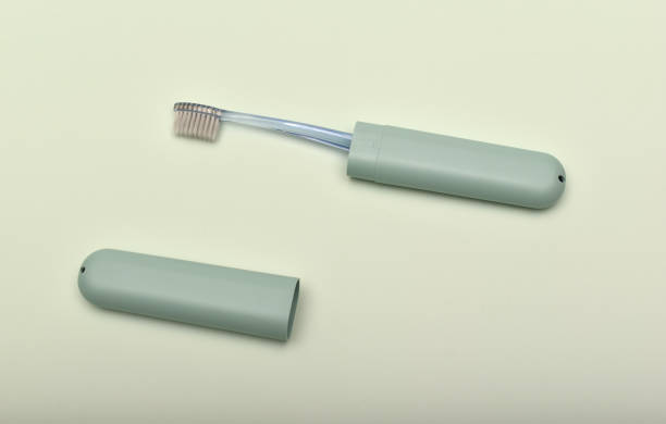 istock A toothbrush case and a toothbrush on a green background. 2162148814