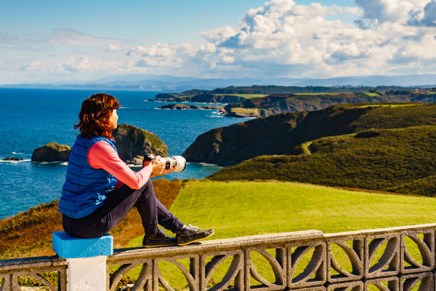 istock Tourist with camera on Asturias coast, Spain 2162149118