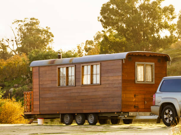 Tuscaloosa, Alabama, USA - November 9, 2008:  Airstream travel trailer being pulled through campground with autumn foliage and leaves on ground.