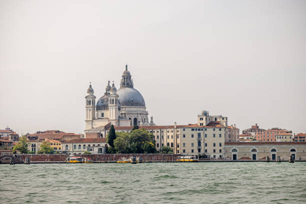 Venice, Italy - June 7th 2024:  View to Basilica Santa Maria Della Salute which where completed in 1681. It is seen from a vaporetto sailing east of Punta della Dogana