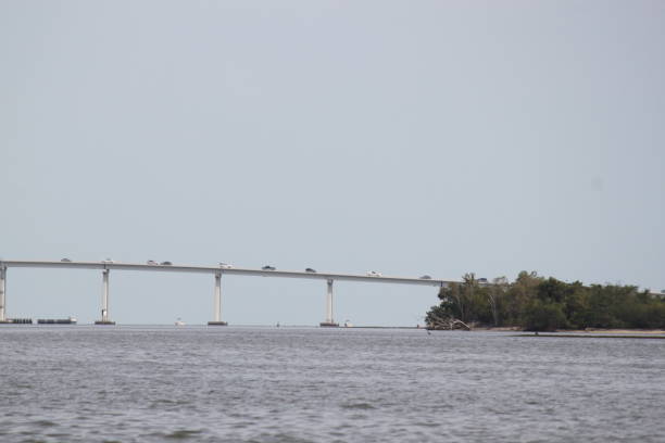 Cape Coral, Florida On the Caloosahatchee River looking at a bridge in Cape Coral, Florida. caloosahatchee bridge stock pictures, royalty-free photos & images
