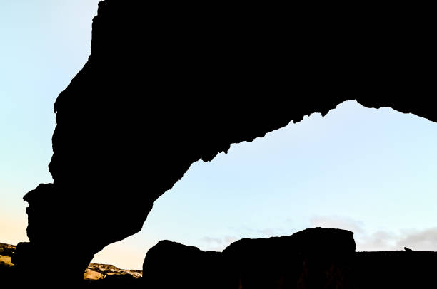 istock A large rock formation with a cave in the middle 2162150610