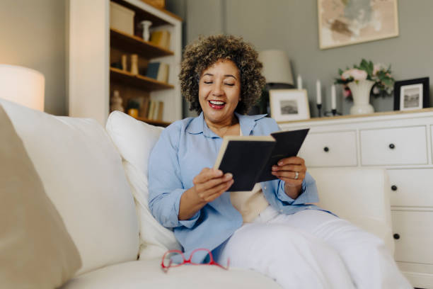 istock Woman reading book and resting at home 2162151237