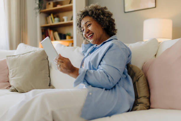 Woman resting at home and using digital tablet at home