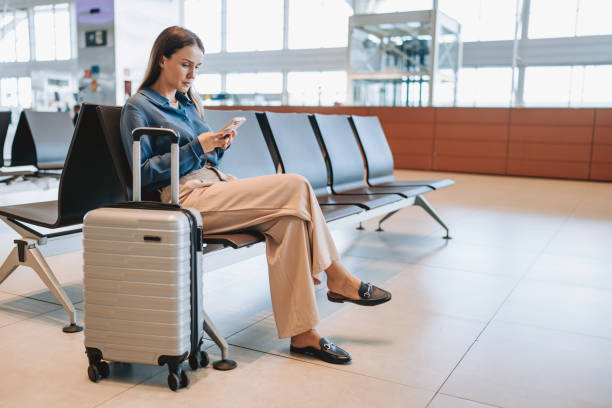 istock A woman at the airport using smartphone 2162152464