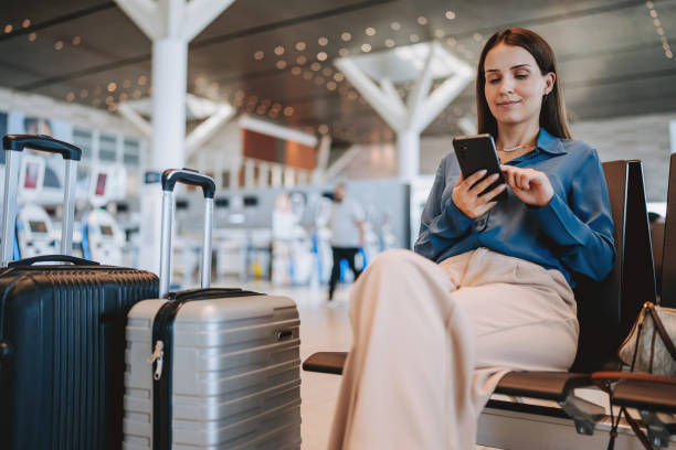 istock A woman at the airport using smartphone 2162152465