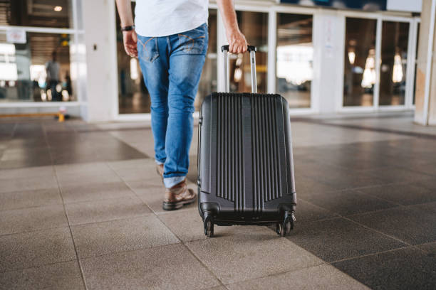 istock Arriving at the airport with a rolling suitcase 2162152757