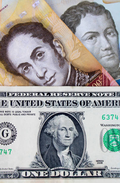 istock Benezuelan bills next to American Dollar 2162153417