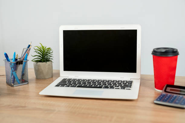 istock Empty notepad with pen laptop calculator coffee on a office wooden surface, nobody 2162153693