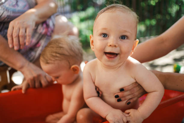Baby twins having fun together on summer day, they are enjoying staycation