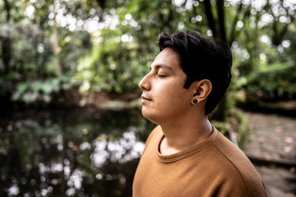 istock Young man relaxing and inhaling on forest 2162155644
