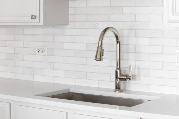 istock A kitchen sink detail with a marble subway tile backsplash. 2162158860