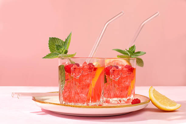 istock Lemonade cocktail,mojito with tequila, gin, rum, vodka, liqueur, lime, ice and fresh raspberries, bar and party concept, restaurant and cafe advertising card, black background, selective focus. 2162161264