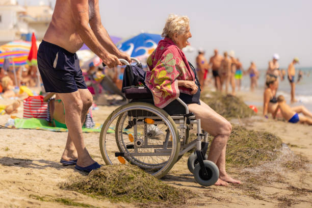 istock Husband Pushing Wife on Beach 2162162518