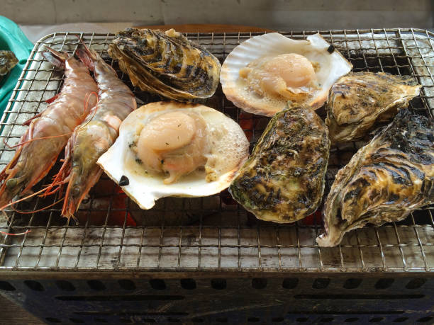 A collection of seafood cooked on a small fire barbecue pit