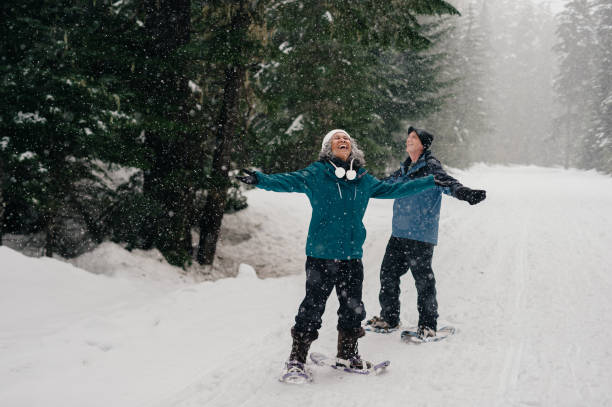 Senior couple enjoys the snow while snowshoeing
