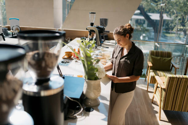 istock Attractive woman checking the menu standing at cafe counter 2162163708