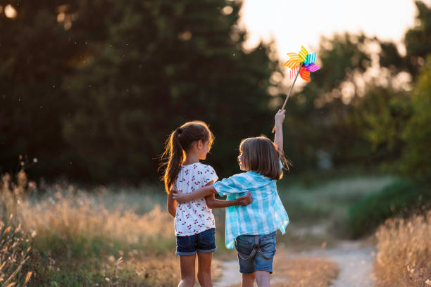 istock Children walking with pinwheel, surrounded by nature 2162166168