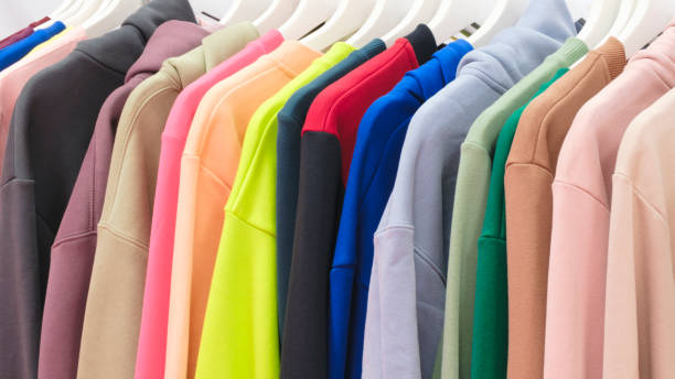 istock Multicolor family clothes on hangers in store 2162167270