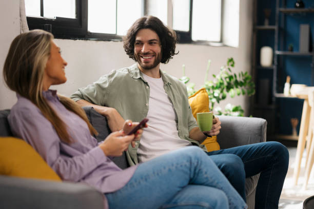 istock Young couple enjoying relaxation time on sofa at home 2162167336