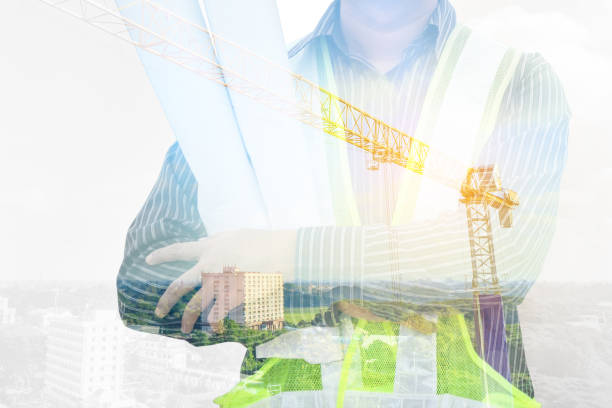 istock Double exposure image of professional engineer in protective helmet and blueprints paper at building construction site 2162174533