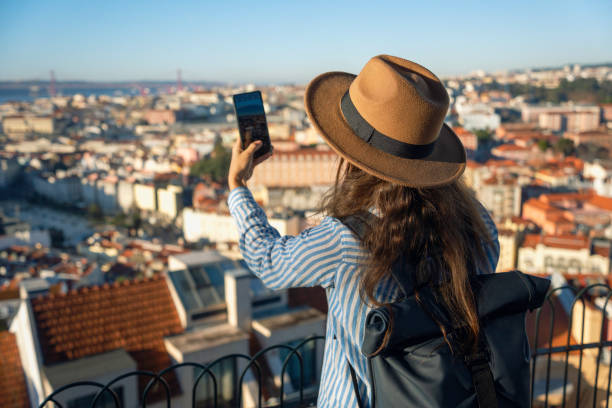 istock Lisbon Staycation. Woman live streams from Alfama. 2162174604