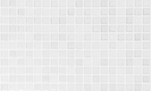 istock White tile wall chequered background bathroom texture. Ceramic brick wall and floor tiles mosaic background in bathroom and kitchen clean. Design pattern geometric with grid wallpaper decoration. 2162174693