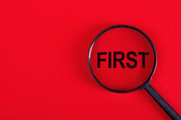 istock Magnifying glass with the inscription FIRST on a red background. 2162175072