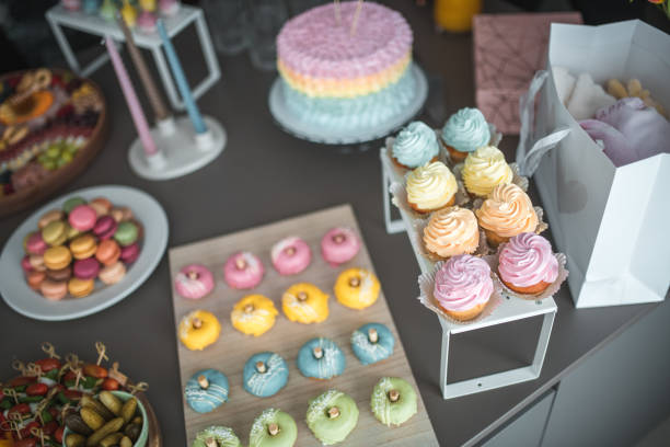 A beautifully curated baby shower celebration with a stunning pastel cake, delicate macarons, and an array of elegant snacks.