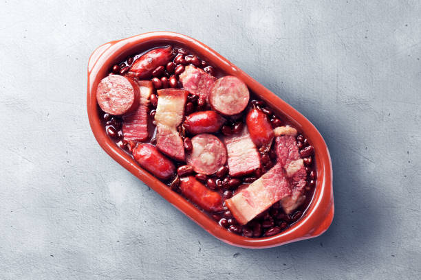 istock brazilian feijoada in ceramic bowl isolated on cement table background. Copy space 2162176841