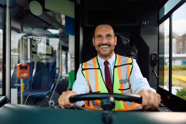 istock Happy bus driver driving through the city. 2162176975