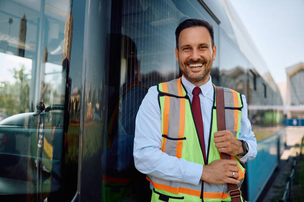 istock Happy driver standing next to a city bus and looking at camera. 2162177043