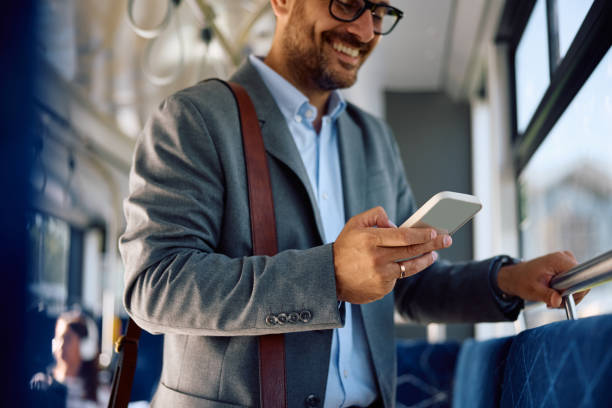 istock Close up of man using cell phone while commuting to work by public transport. 2162177067