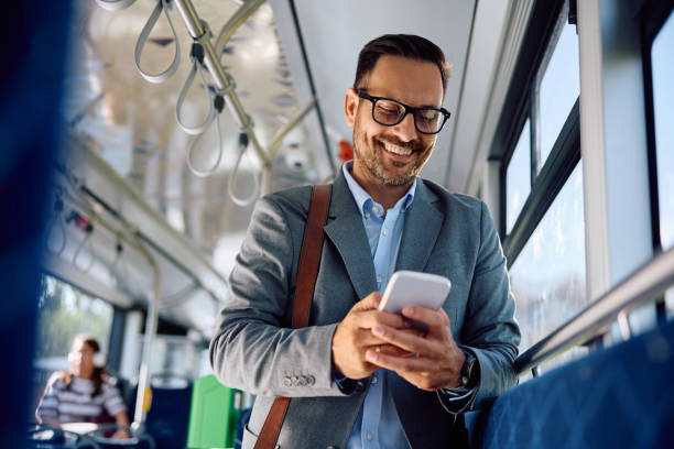 istock Happy businessman text messaging on smart phone while riding in city bus. 2162177076