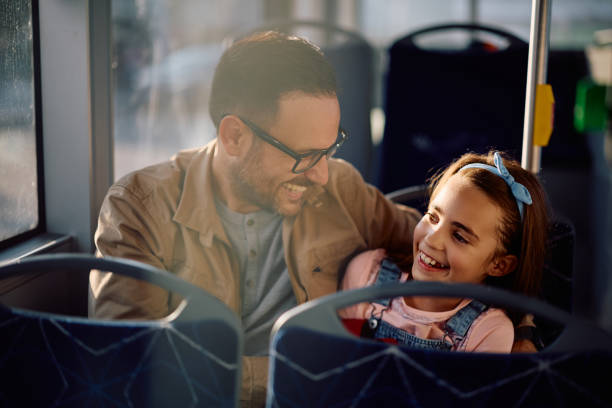 istock Happy father and daughter having fun while commuting by bus. 2162177170