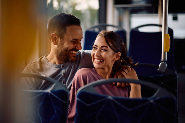 istock Happy couple riding in a bus. 2162177223