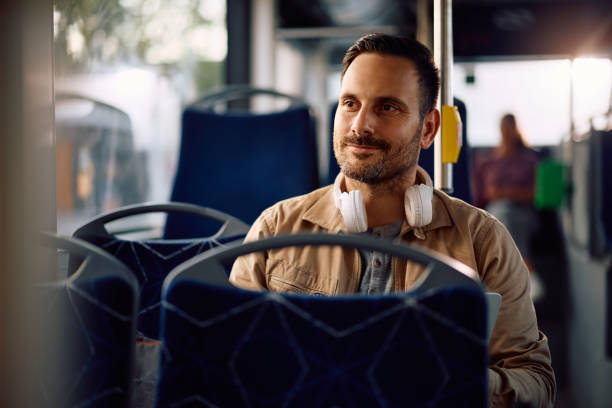 istock Smiling man enjoying while commuting by public transport. 2162177224