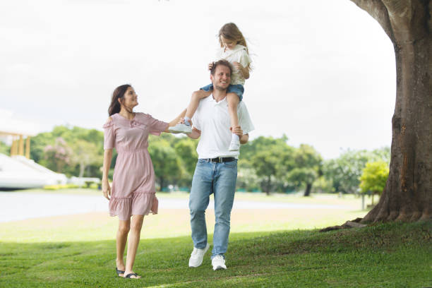 istock Dad piggyback his daughter while walking at the park. 2162183917