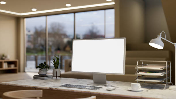 istock A computer with a white-screen mockup on a marble table in a modern, luxurious living room. 2162187304