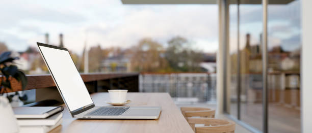 istock A laptop computer on a table on an apartment balcony with city view. outdoors workspace 2162187316