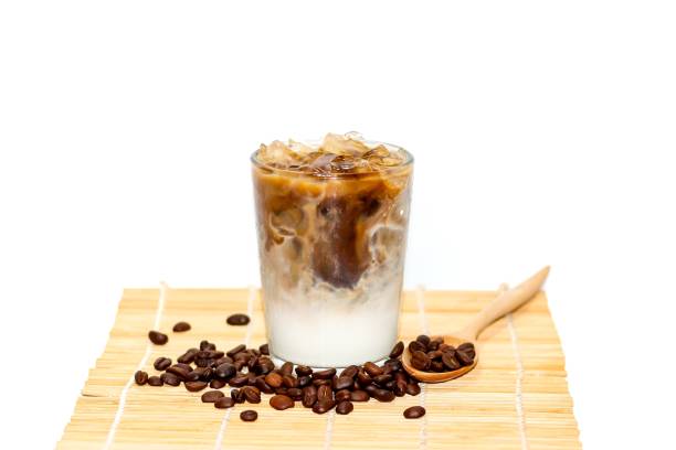 istock Latte ice coffee and coffe beans spread around glass ready for drink put on the sack in white background with concept isolate photo. 2162187472